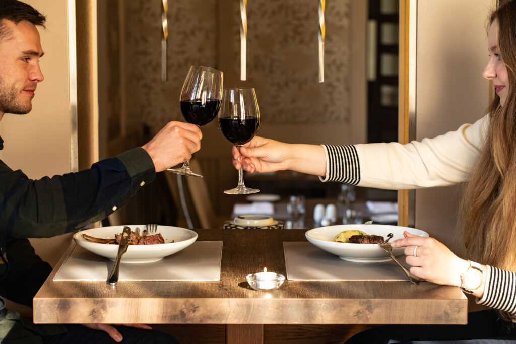 dining danú couple cheers wine